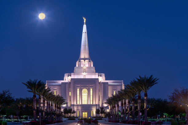 Harvest Moon at Sunrise The Harvest Moon low in the sky over the Latter Day Saints temple in Gilbert, Arizona shortly before sunrise. phoenix stone stock pictures, royalty-free photos & images