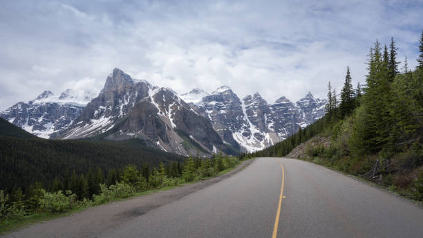 istock Asphalt road leading through beautiful alpine valley 1282065127