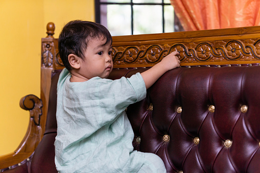 A malay boy being playful at home