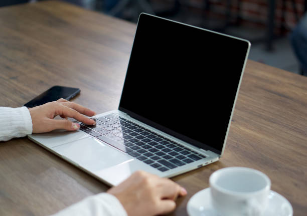 Young woman use her finger press shift key on keyboard to waking computer from sleep mode