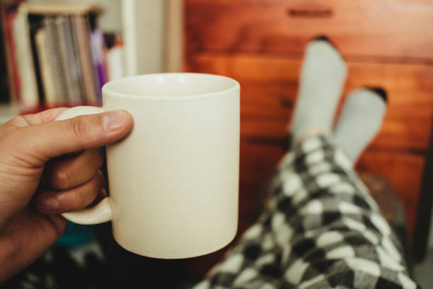 istock Drinking coffee in the morning in pajamas and socks 1282074319