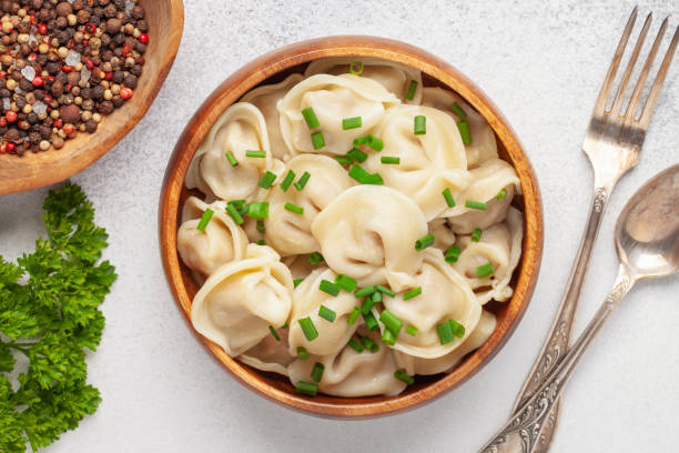 Homemade meat dumplings with onions and parsley- russian pelmeni. Top view Homemade meat dumplings with onions and parsley- russian pelmeni. Top view russian pelmeni stock pictures, royalty-free photos & images