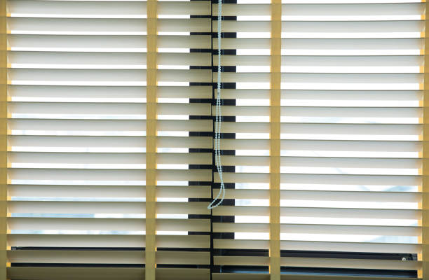 istock Wooden blinds with daylight illuminating through 1282076785