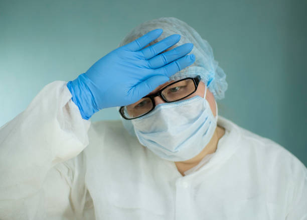 Portrait of a tired doctor in a medical mask. stock photo