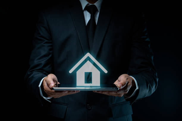istock Businessman using tablet with home icon hologram effect. 1282081012