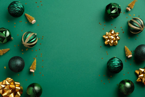 istock Christmas green background with baubles and golden decorations. Xmas frame with copy space. Greeting card mockup, banner template. 1282081067