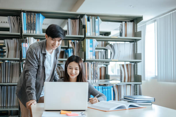 istock Students studying in the library with laptop at the university. Education concept. 1282081749