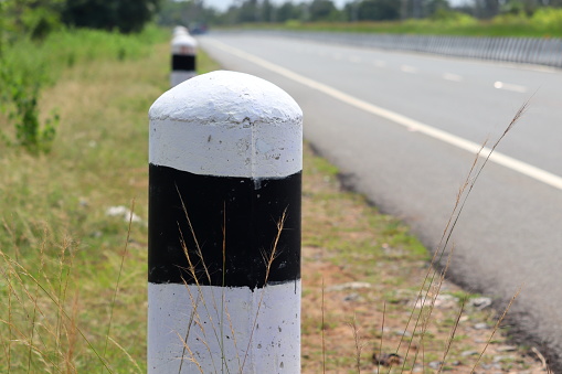 pole black and white symbol at the road. Milestones,