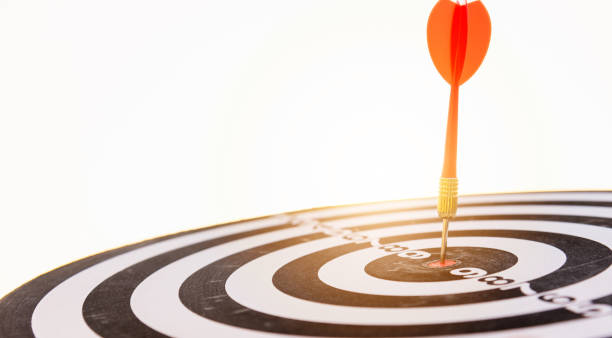 istock Dart arrow hit center on bullseye dartboard is target 1282084528