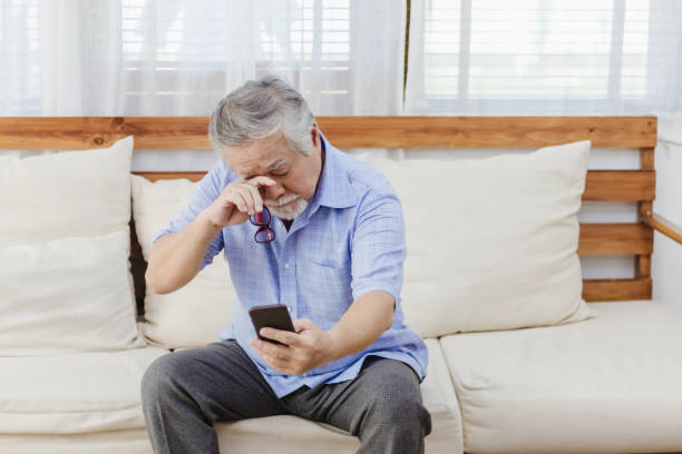 istock Asian senior fatigue man taking off glasses during using smartphone 1282086140
