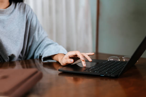 istock High school or college student learning tutoring on desk and reading, doing homework, lesson practice preparing exam on laptop at home. 1282086155