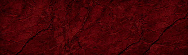 istock Red black abstract rough background. Toned rock texture with cracks and veins. Dark red stone background. 1282087166