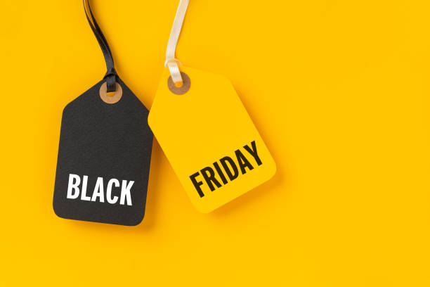 istock Sale tags with Black Friday written on yellow background 1282089813