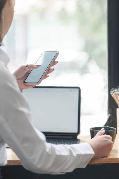 istock Businesswoman using smartphone while sitting in office, closeup view. 1282090588