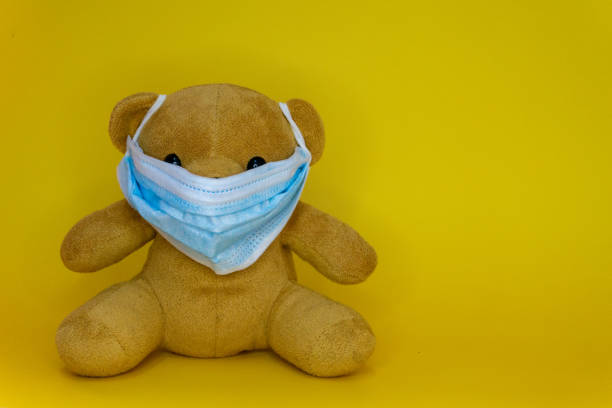 istock Toy bear wearing protective medical mask. 1282090826