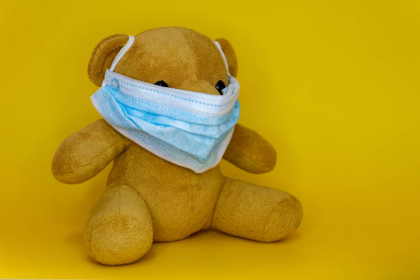 istock Toy bear wearing protective medical mask. 1282090829