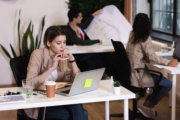 istock Portrait of a young female freelancer working in an office while sitting at a table. 1282094339