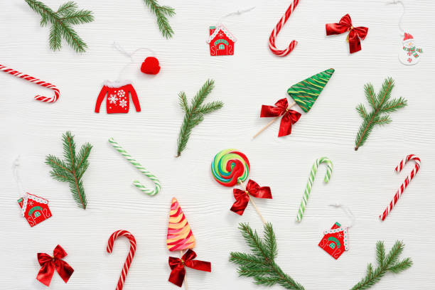 istock Christmas sweets assorted top view, green fir branches. Bright New Year candy and lollipops. 1282095397