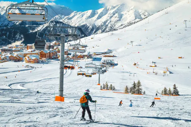 Photo of Skiers exercising on the slope and ski lifts, France, Europe