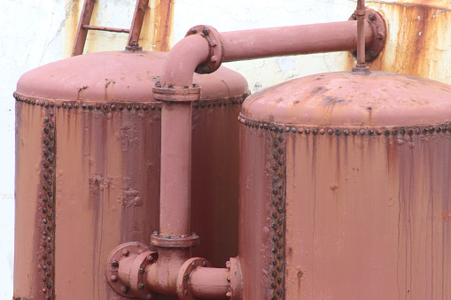 Close up rusty old oil tanks outside