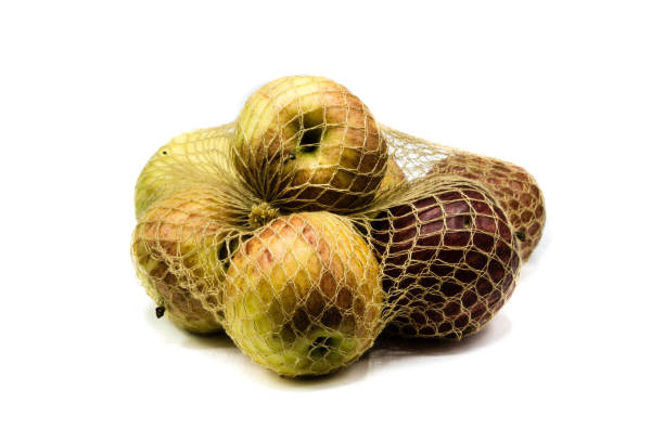 istock Apples in the net isolated on white background 1282100079