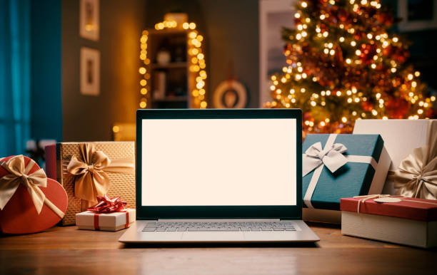 istock Laptop with blank screen and Christmas gifts 1282100181