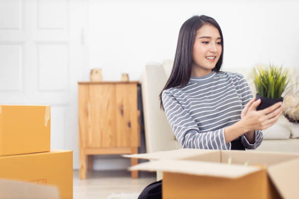 istock Worker In house Checking Boxes Using Digital Tablet.Start up small business entrepreneur SME or freelance man and woman working  at home concept, Young Asian small business owner,online marketing. 1282100895