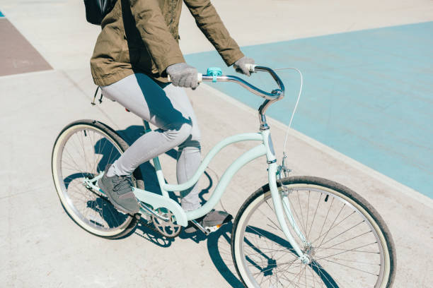 istock Woman in green jacket riding a bicycle 1282101103