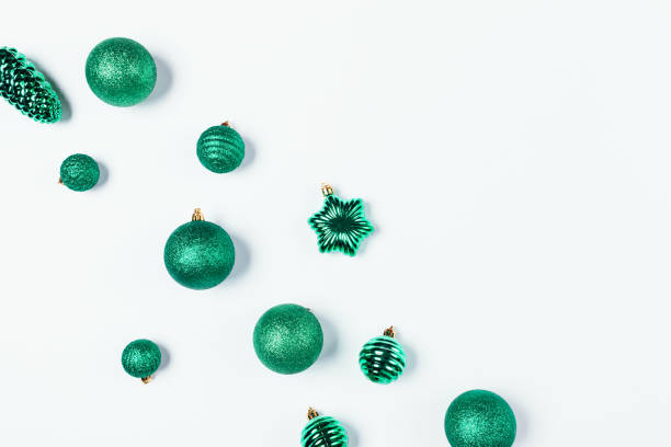 istock Christmas baubles in green color on white background 1282101121