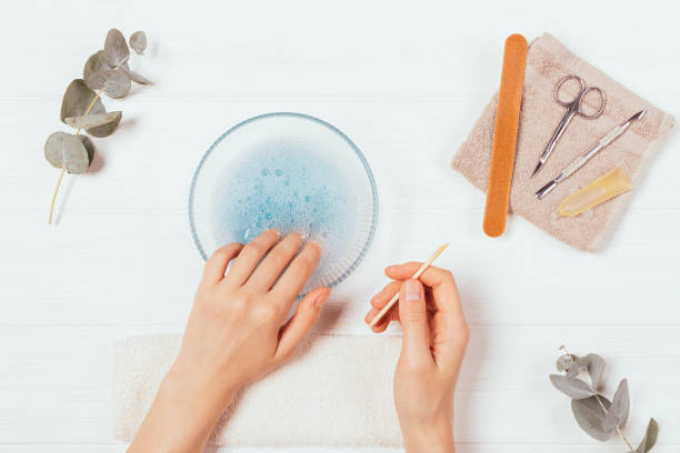 istock Process of manicure at home, female hands make cuticle bath 1282101220