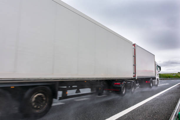 istock Mega trailer or road train circulating on a day with bad weather due to rain 1282101848