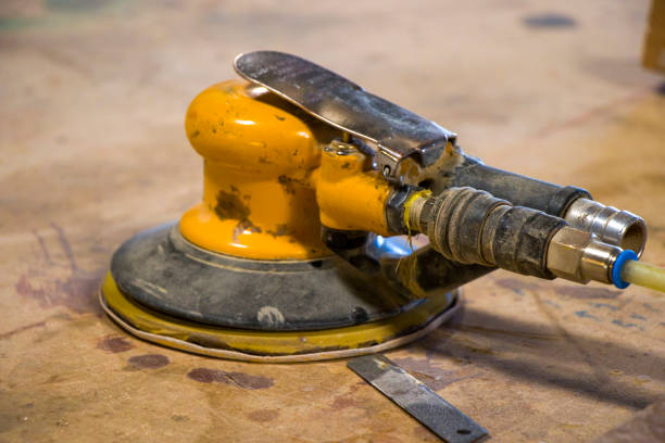 istock Yellow sander close-up on the table, dirty sander 1282103038