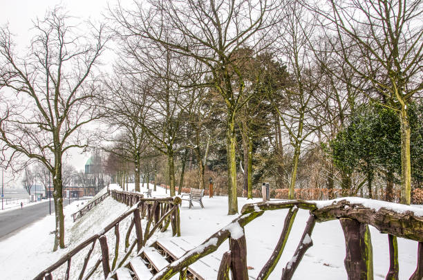 Rotterdam, The Netherlands, March 3, 2018: winter scene at th elevated promenade at the Park overlooking park quay and the river Nieuwe Maas