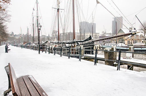 Rotterdam, The Netherlands, January 22, 2019: view along the quay of Veerhaven marina with historic sailing ships on  a cold day in winter