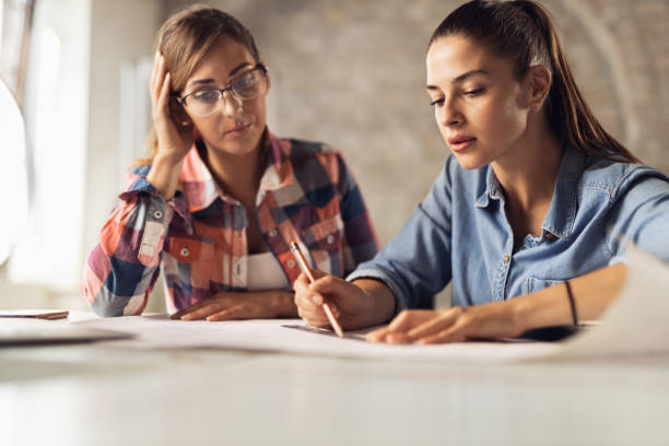 istock Two female architects working on blueprints in the office 1282107735