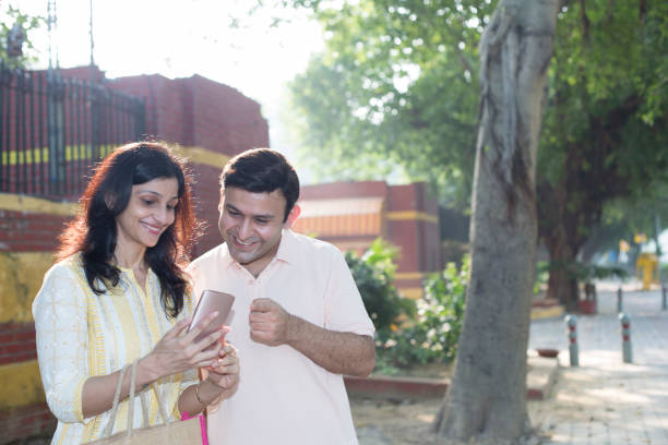 istock Young couple shopping online using mobile phone 1282108442