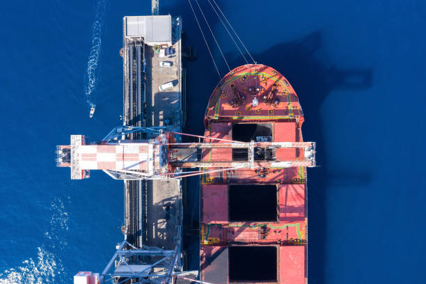 istock Coal carrier Cargo Ship docked at a commercial pier during unloading operation, Aerial view. 1282109356