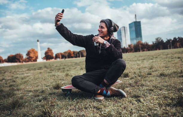 Young Handsome Vlogger Taking Selfies On Skateboard