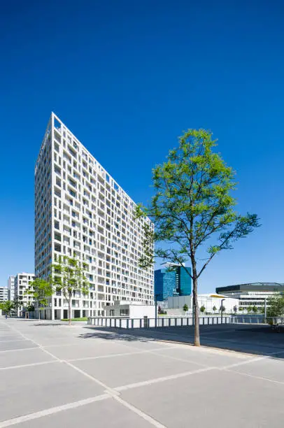 The modern DC Living appartment building in Vienna's Donau City, Austria with blue sky and straight perspective.