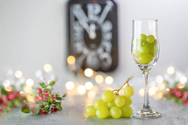 Midnight on New year's eve in Spain Midnight on New year's eve in Spain eating twelve grapes champagne grapes stock pictures, royalty-free photos & images