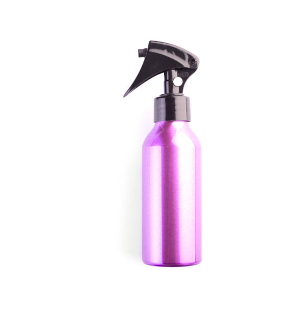 istock Pink cosmetic spray bottle isolated on white background. Plastic container closeup 1282113413