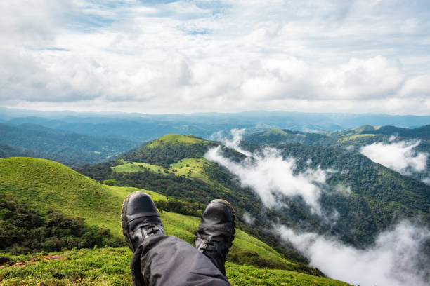 istock hiker resting at hilltop with breathtaking mountain layers in background 1282114844