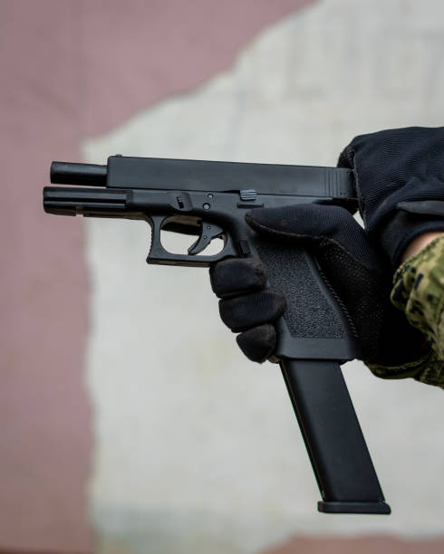 istock Person holding gun Glock 1282118244