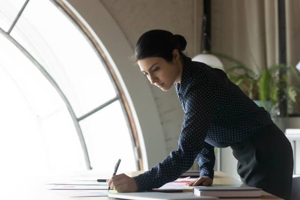 istock Young indian businesswoman work with paperwork in office 1282120133