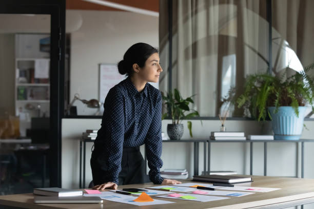 istock Pensive confident indian businesswoman visualizing in office 1282120135
