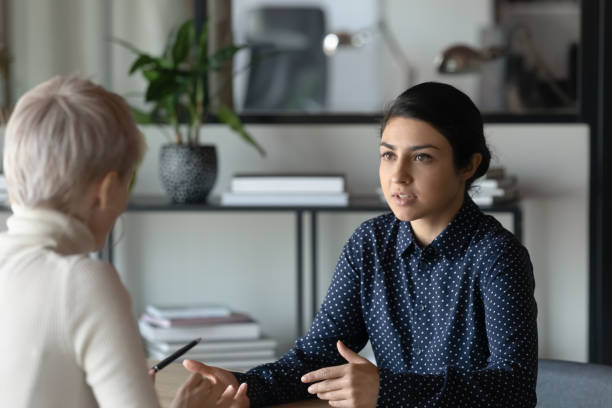 istock Multiracial female colleagues discuss ideas at meeting 1282120140