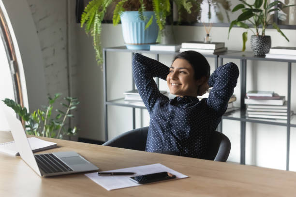 istock Happy indian female employee relax at workplace 1282120161