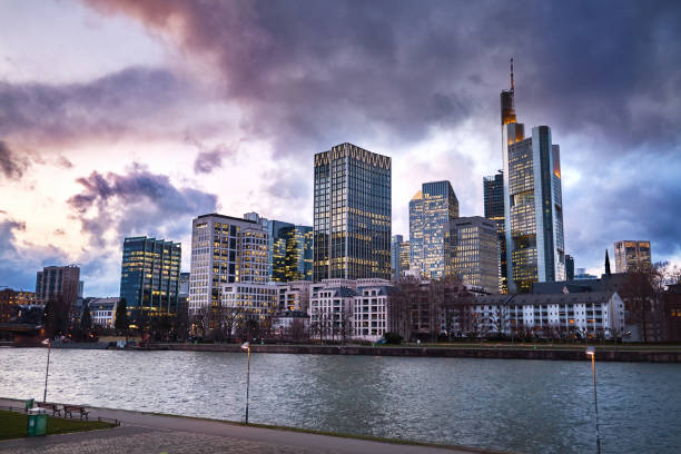 Colorful cloudscape at twilight over Frankfurt financial district skyline, view from across the river Main