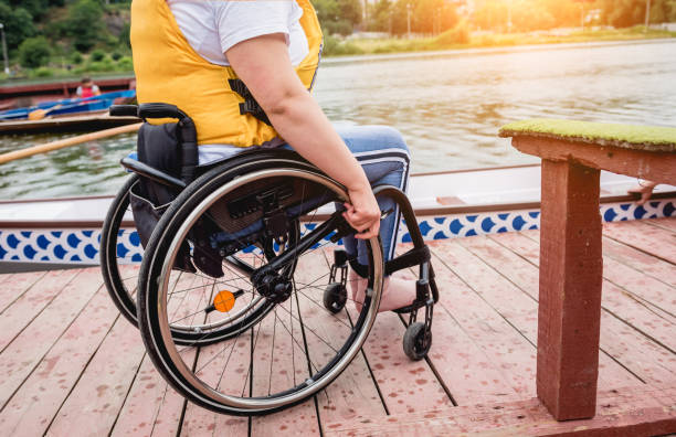 istock People with disabilities in life vests on the pier. 1282123863
