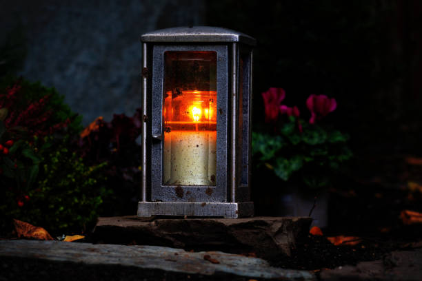 istock Grave lantern with burning candle at night 1282124634